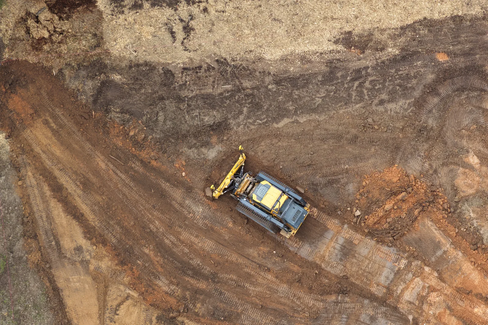 Aerial view of a Titan Built compact track loader grading a cleared site near Charlotte, NC