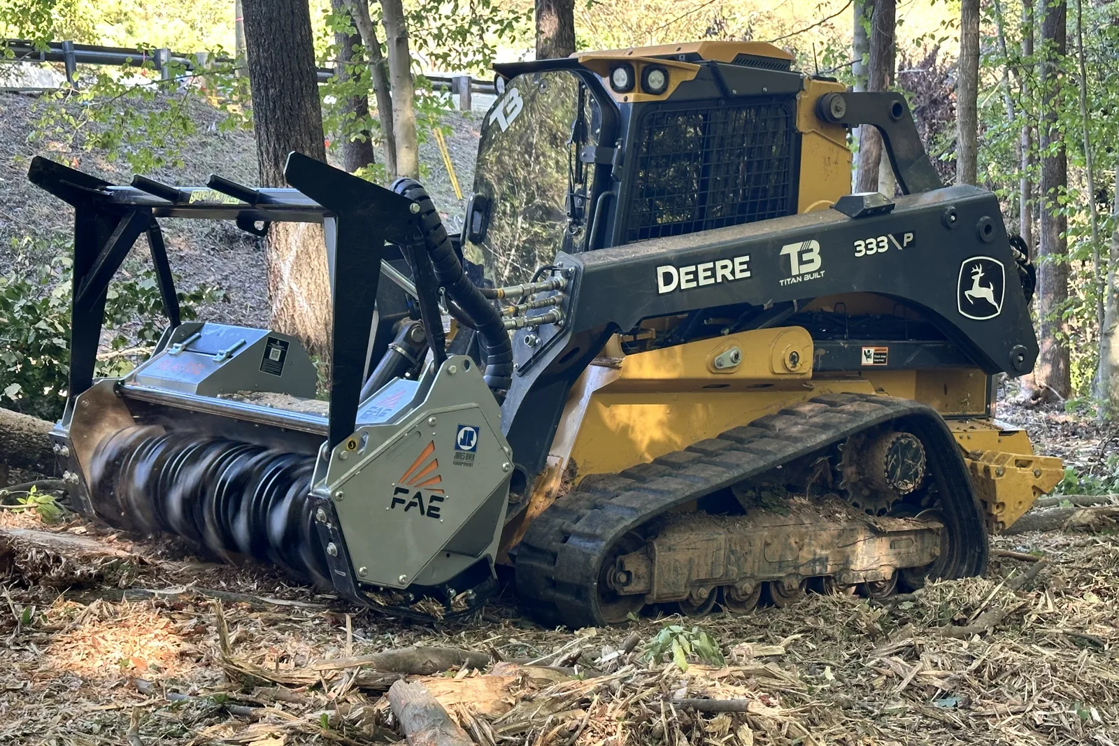 Titan Built Deere 333P forestry mulcher clearing brush and small trees in Charlotte, NC